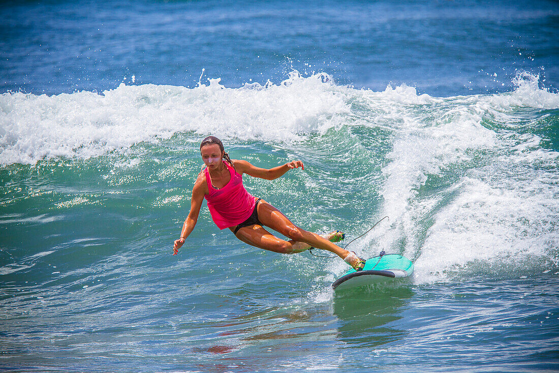 Surfer girl catches wave in high heels.