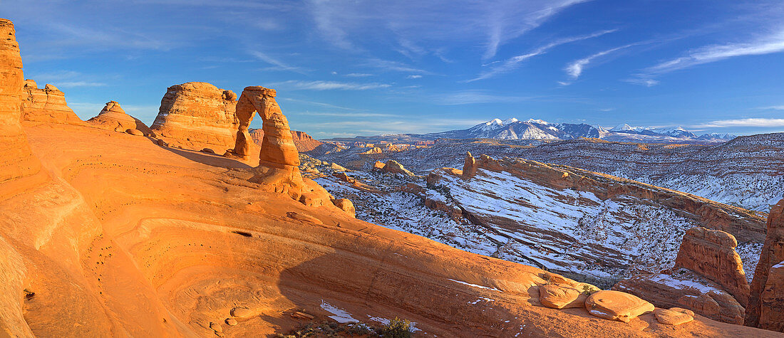 Delicate Arch glows as the sun sets over Arches National Park, Utah on December 26, 2006. The La Sal mountain range in the background has snowcapped peaks that tell of recent snowfall.