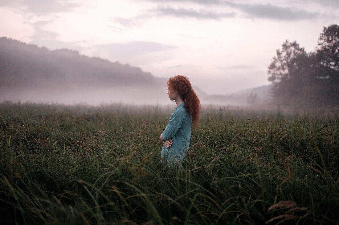 Caucasian woman standing in remote field