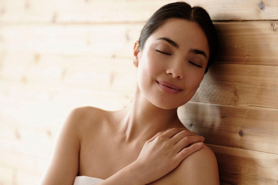 Hispanic woman relaxing in sauna