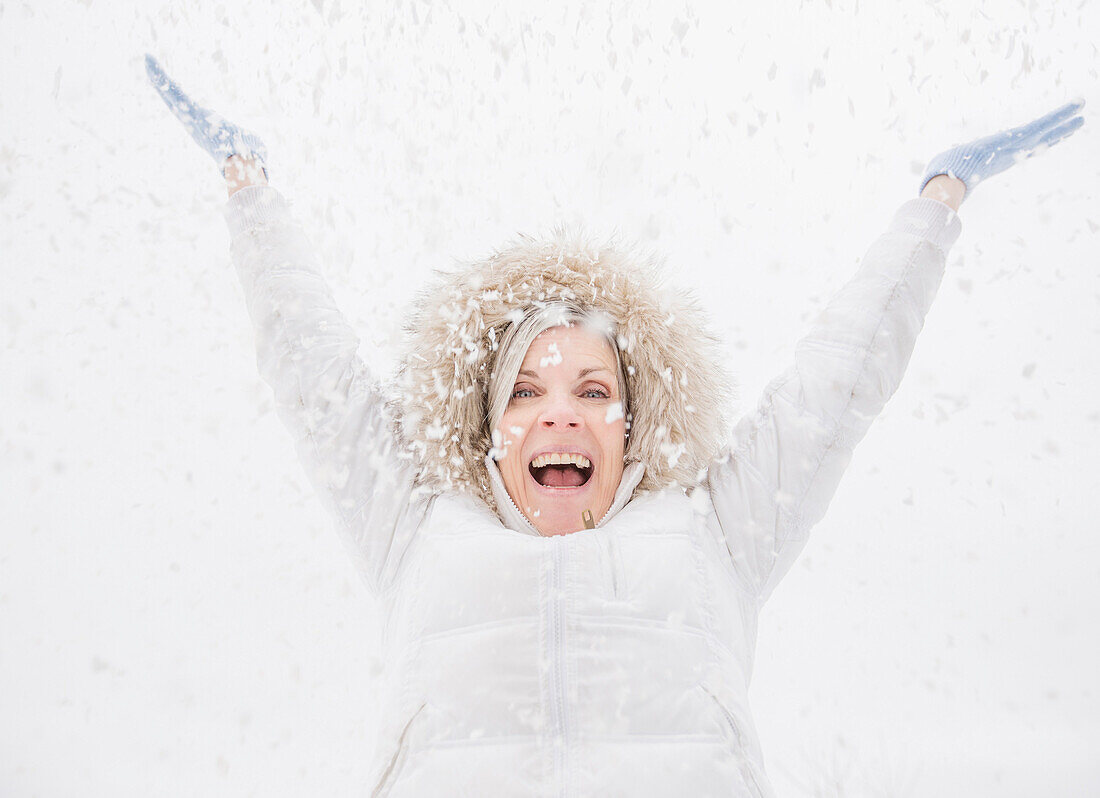 Caucasian woman playing in snow