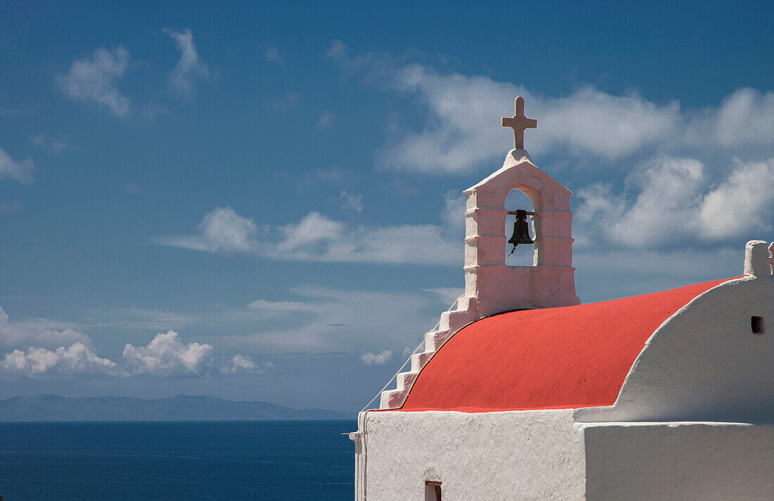 Traditional bell arch and seascape under blue sky