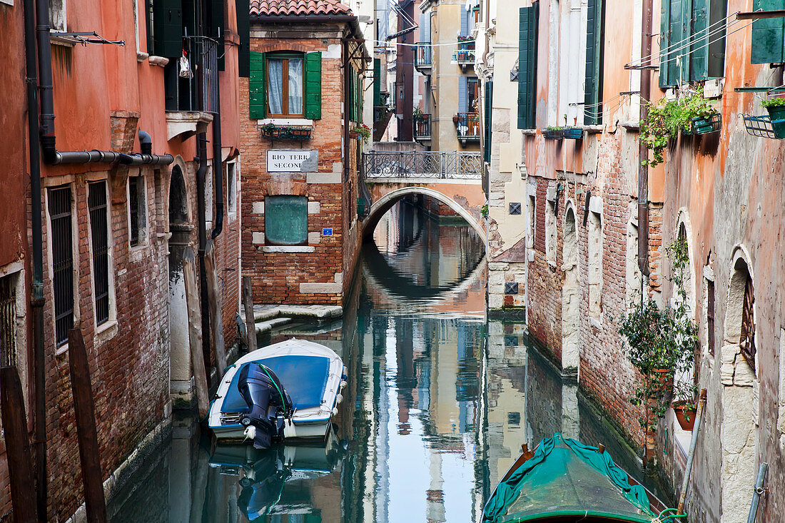 Boats moored in a tranquil canal between buildings Venice, Italy