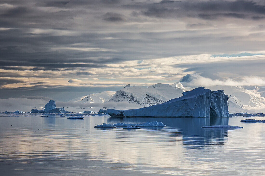 Iceberg in Gerlache Strait in front of glaciated peaks on Antarctic Peninsula, Antarctica