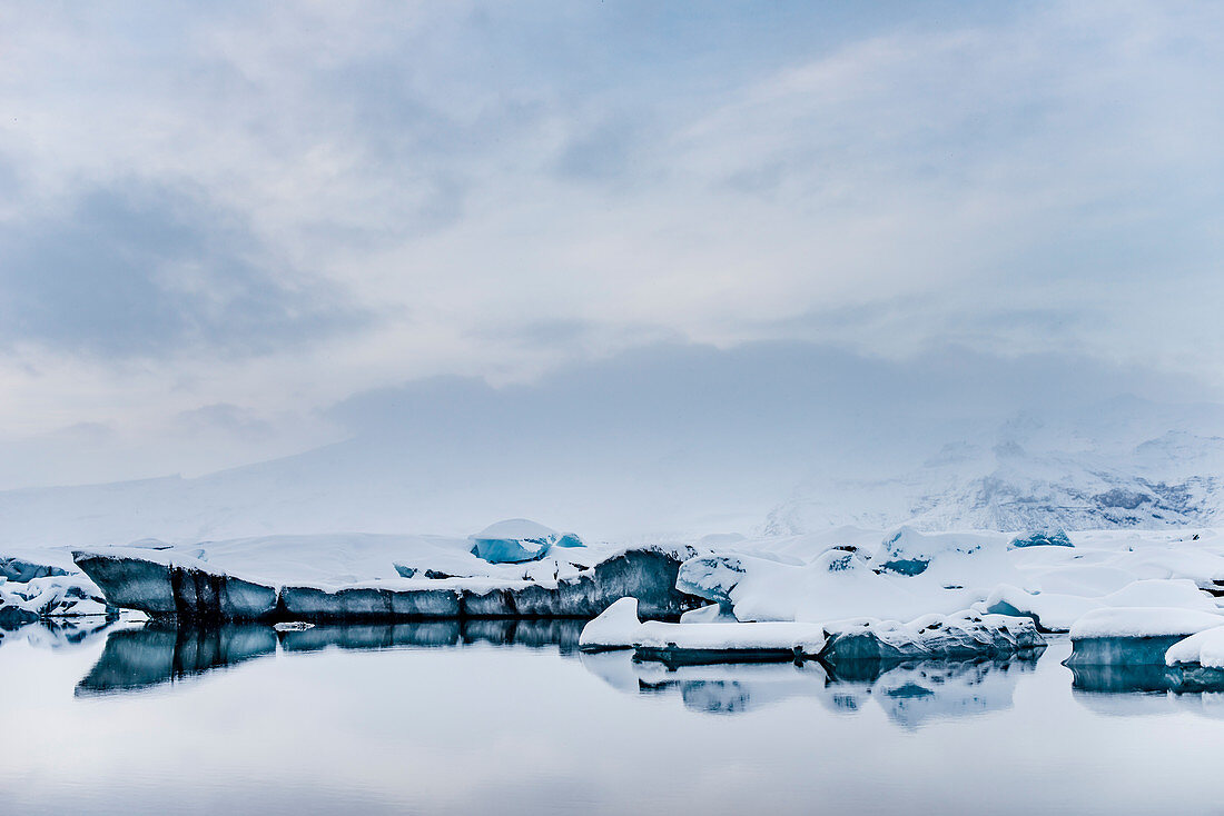 Joekulsarlon with growler at sunset, Glacierlagoon, Vatnajoekull Glacier in Winter, Iceland