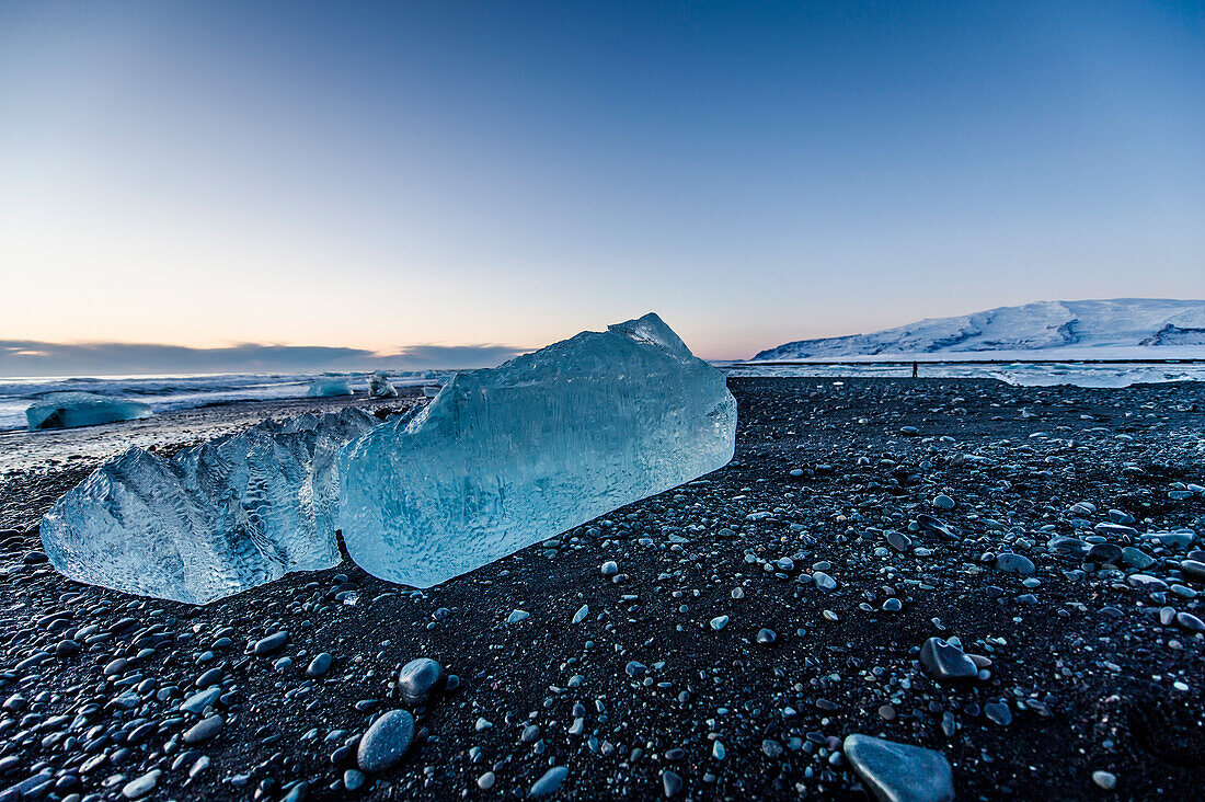 Joekulsarlon, Growler on the beach at sunrise, Glacierlagoon, Vatnajoekull Glacier, Winter, Iceland