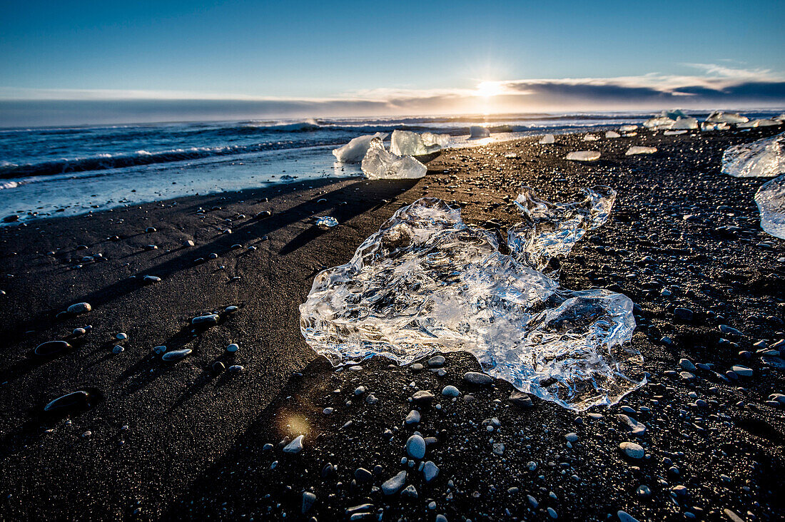 Joekulsarlon, Growler on the beach at sunrise, Glacierlagoon, Vatnajoekull Glacier, Winter, Iceland