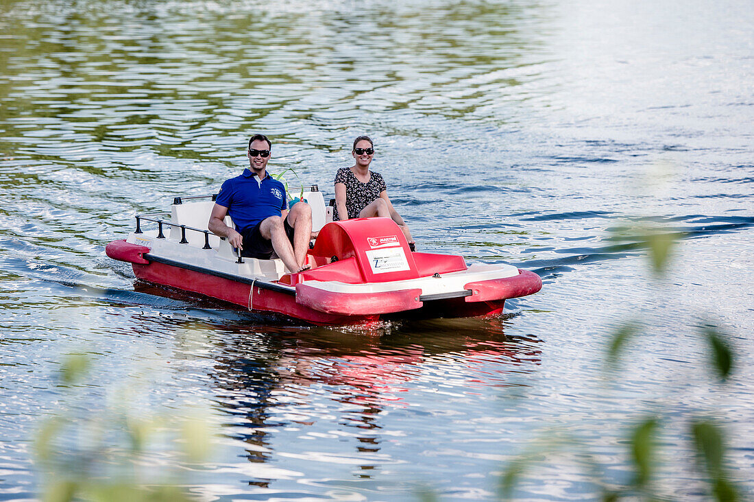 Boat cruising on Lake Bucher reservoir, Rainau, close to Aalen, Ostalbkreis, Baden-Wuerttemberg, Germany