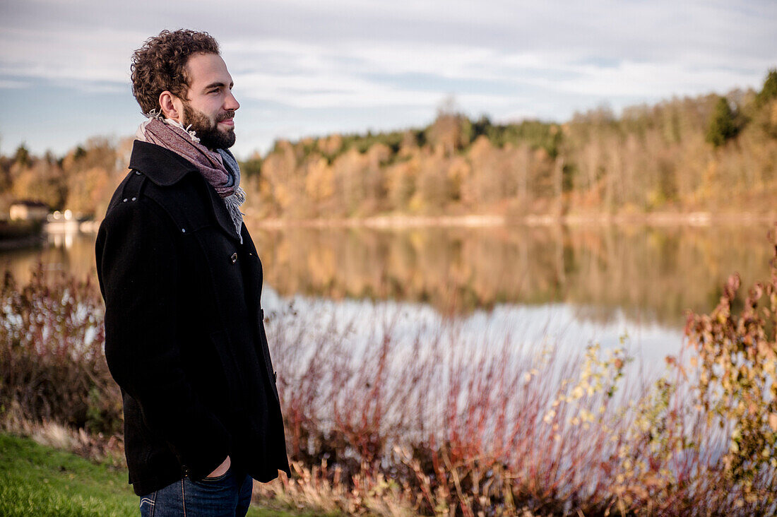 Man standing at Lake Bucher reservoir, autumn, Rainau, close to Aalen, Ostalbkreis, Baden-Wuerttemberg, Germany