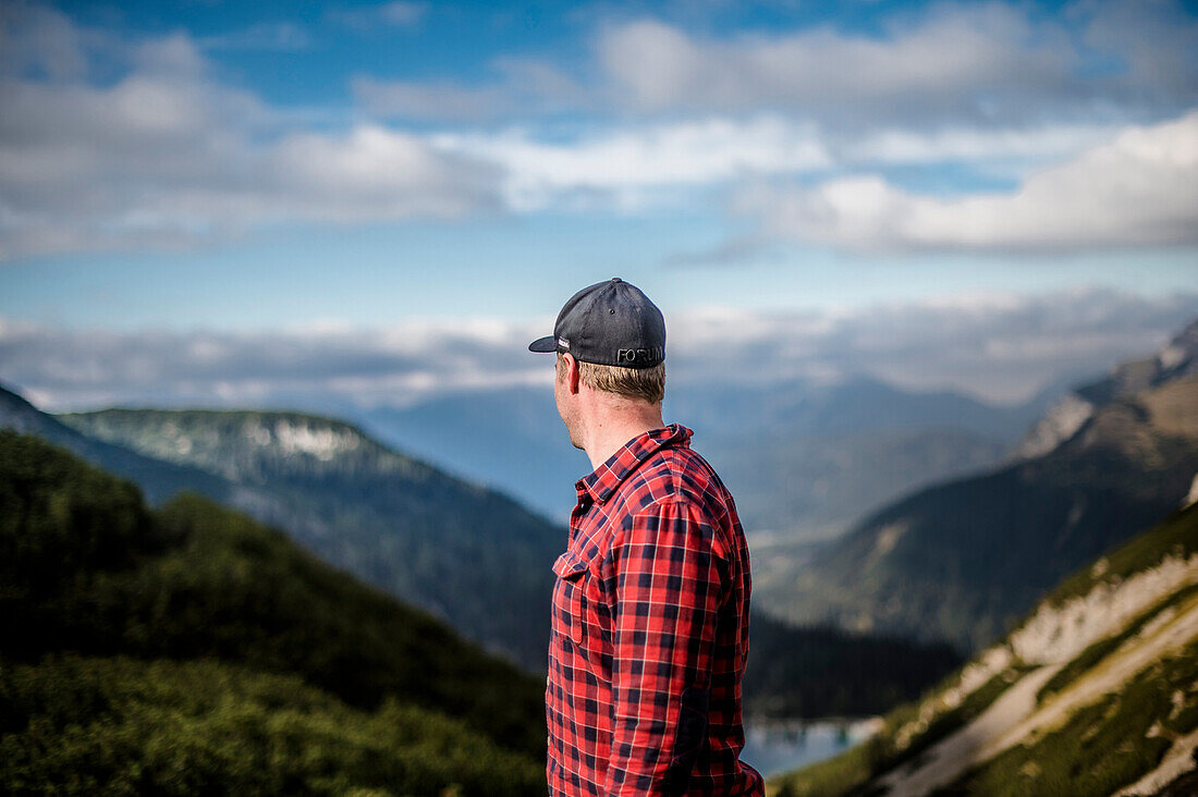 Man looking into the distance above lake Seebensee, Mieminger Range, Zugspitze area, Alps, Tyrol, Austria