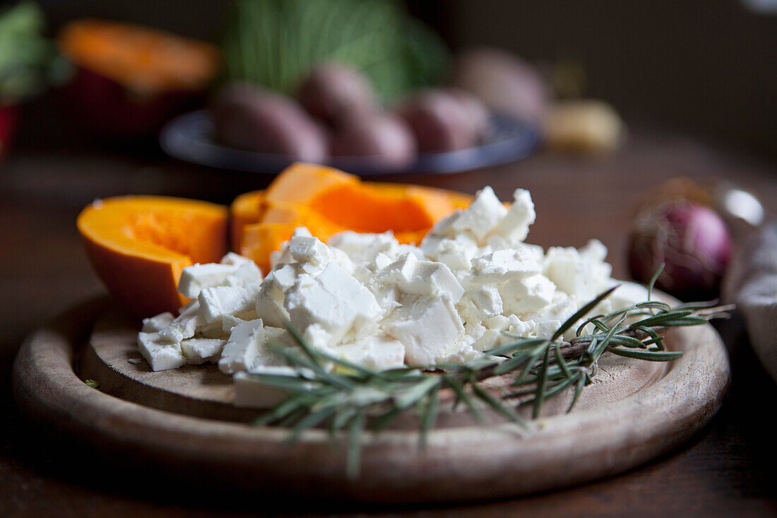 Close-up of feta cheese with rosemary on cutting board