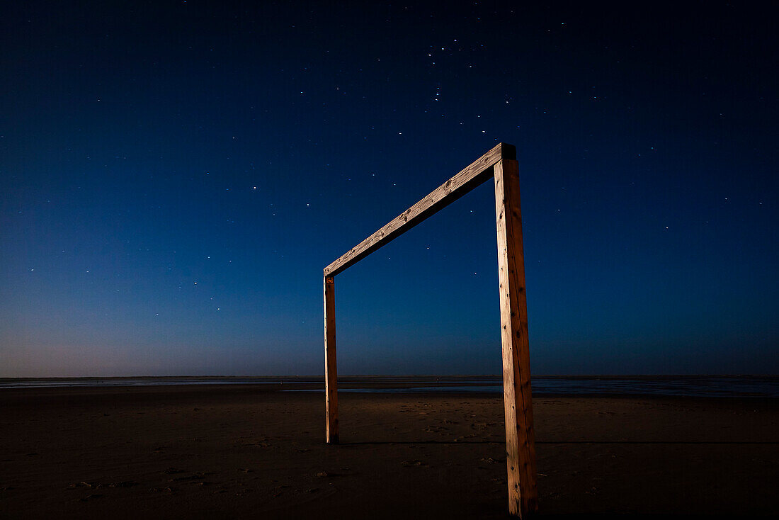 Soccer goal on beach at night