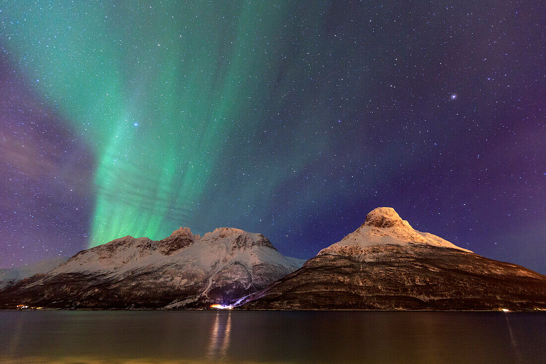 The Northern Lights illuminates the snowy peaks Oteren Storfjorden, Lyngen Alps, Troms, Lapland, Norway, Scandinavia, Europe
