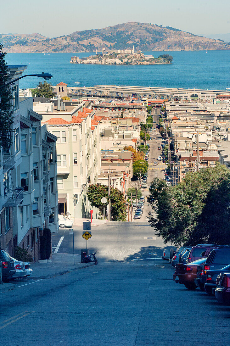 Steep city street, San Francisco with the prison island of Alcatraz in the bay, San Francisco, California, United States of America, North America