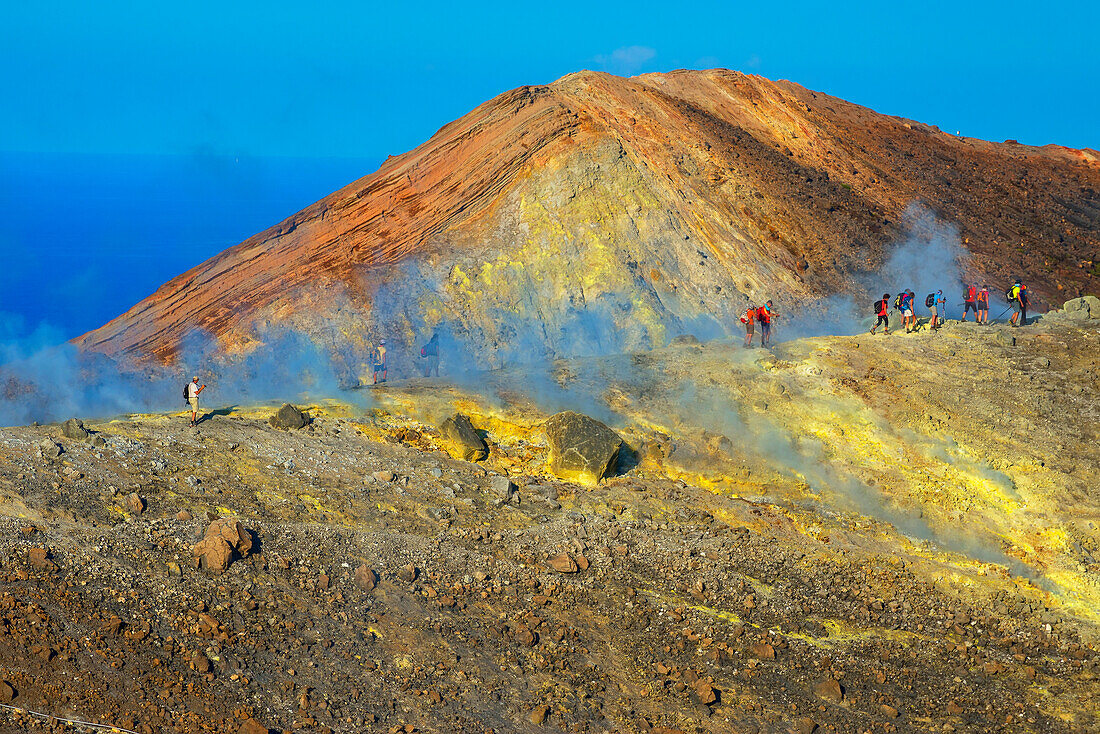 People walking through fumaroles on Volcano Gran crater rim, Vulcano Island, Aeolian Islands, UNESCO World Heritage Site, north of Sicily, Italy, Mediterranean, Europe