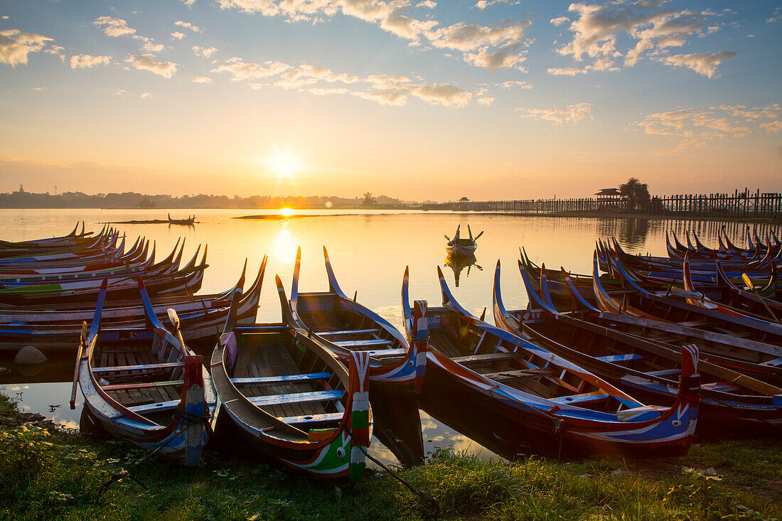 Boats on the Taungthaman Lake near Amarapura with the U Bein teak bridge behind, Mandalay, Myanmar Burma, Southeast Asia