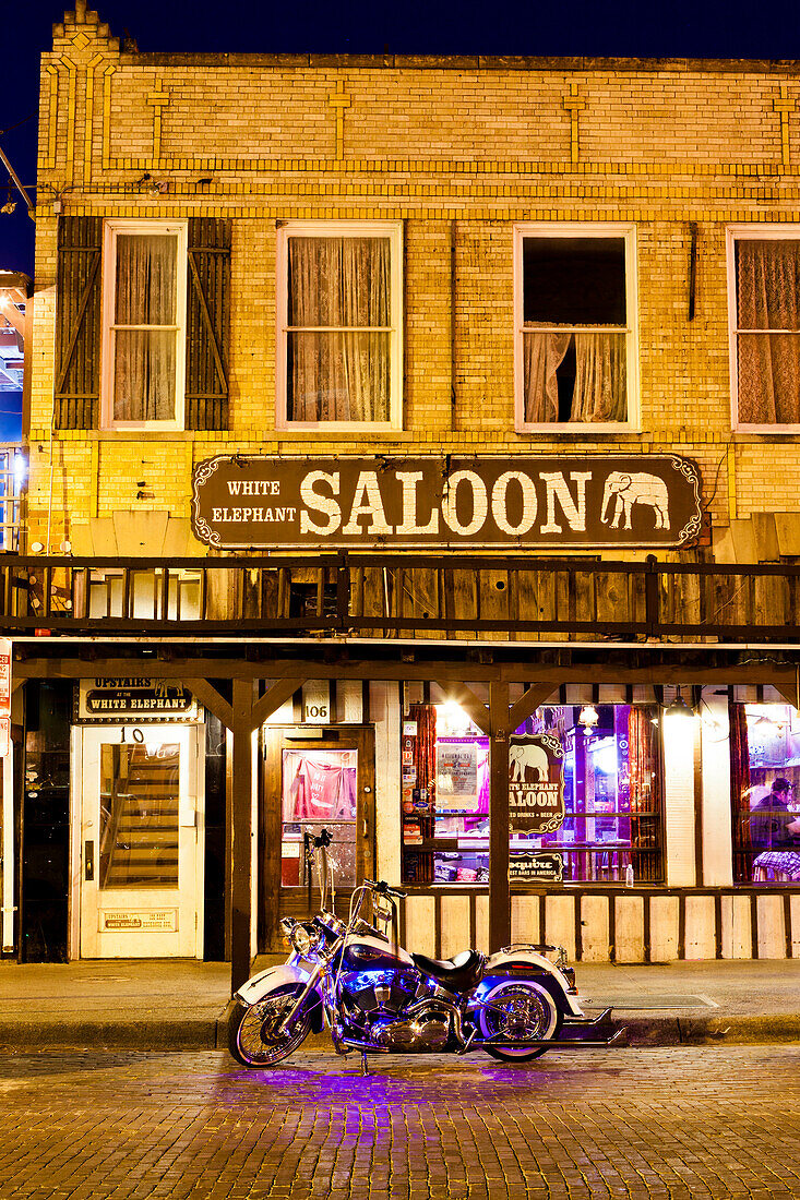 Bike outside a bar in Fort Worth Stockyards at night, Texas, United States of America, North America
