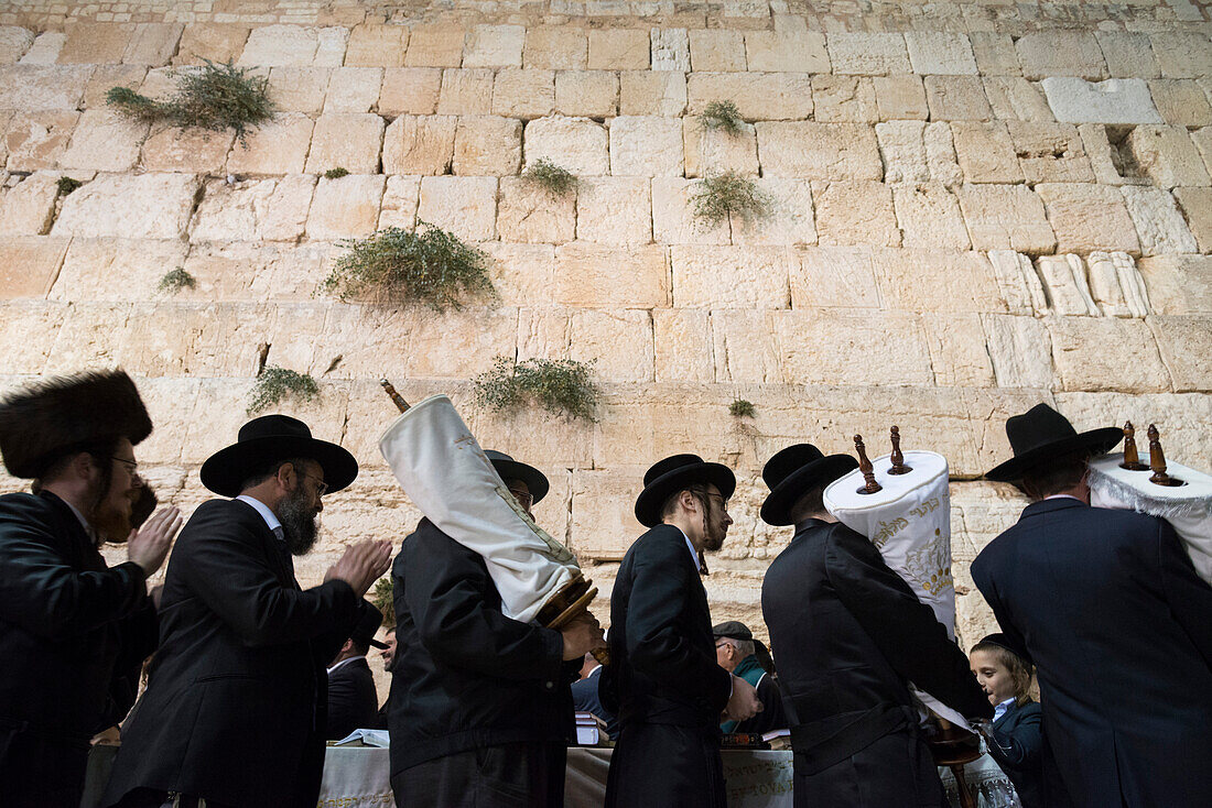 Orthodox Jews dancing with Torah scrolls during Simhat Torah festival, Western Wall, Jerusalem Old City, Israel, Middle East