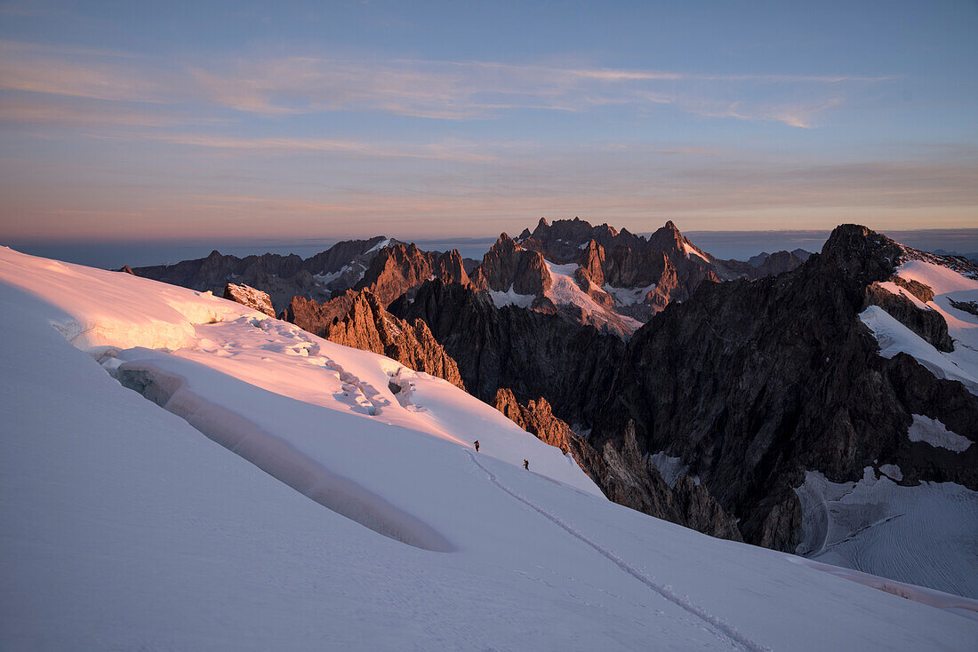 Morning dawn ascending the Barre des Ecrins with views of the Meije, Ecrins National Park, Dauphiné, France