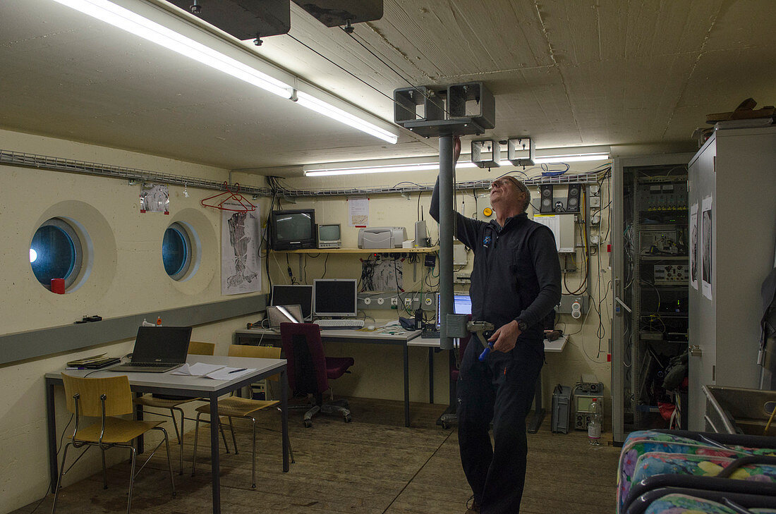 A scientist in the so-called bunker during an artificially triggered massive avalanche in the full-scale avalanche dynamics test site of the Swiss WSL Institute for Snow and Avalanche Research (SLF), Vallée de la Sionne, Western Bernese Alps, canton of Va