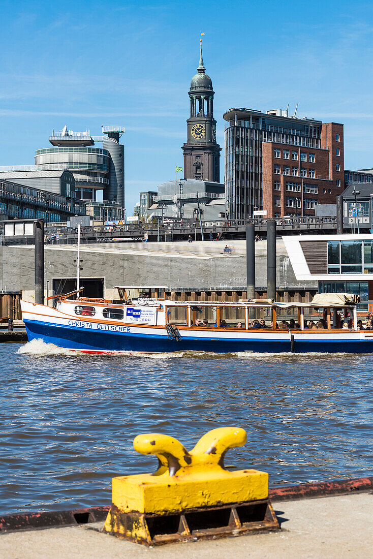 A launch on harbour cruise with the tower (132,14 m high) of Michel, main church Sankt Michaelis in the background, Hamburg, Germany