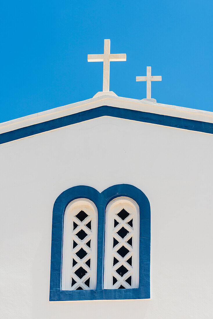 Side view with window and 2 crosses of a traditionally built blue white Greek orthodox chapel, Kamari, the Cyclades, Santorini Greece