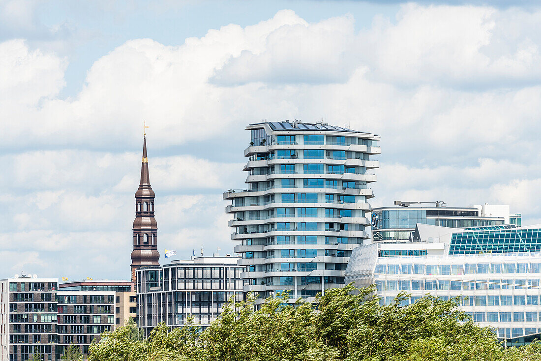 Harbour city skyline with residence high rise building Marco Polo Tower, Unilever company headquarters (on the right) and the tower of the main church Sankt Katharinen, Hafencity, Hamburg, Germany