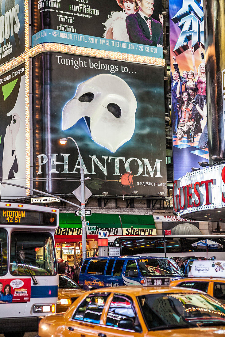 Times Square lights at night with Phantom billboard and busy traffic.