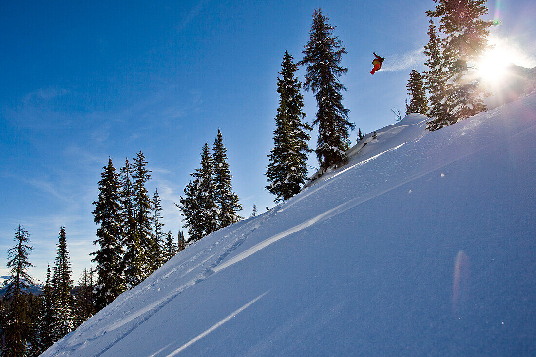 A man hits a backcountry jump on his snowboard on Togwotee Pass in Wyoming.