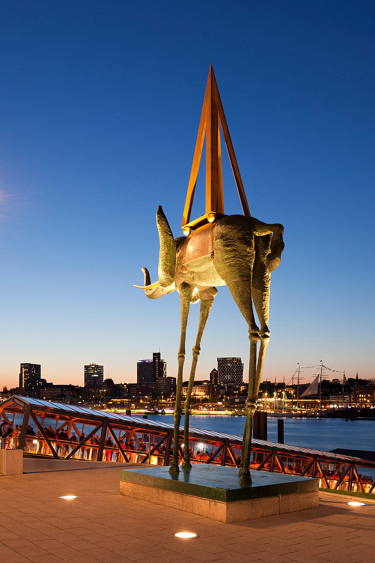 Sculpture of an elephant by Salvador Dali in front of the Stage Theatre, view over the Elbe river to the Elbphilharmonie, Hamburg, Germany