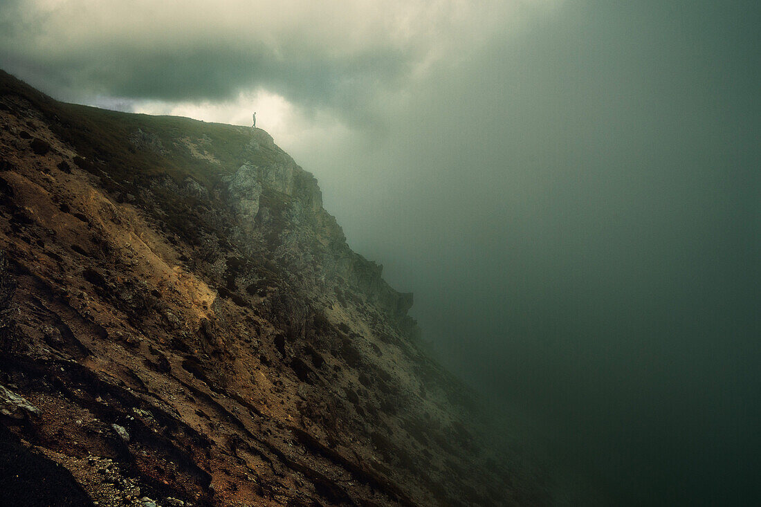 Hiker surrounded by thick fog, Puez-Geisler Nature Park, Dolomites, Unesco world heritage, South Tyrol, Italy