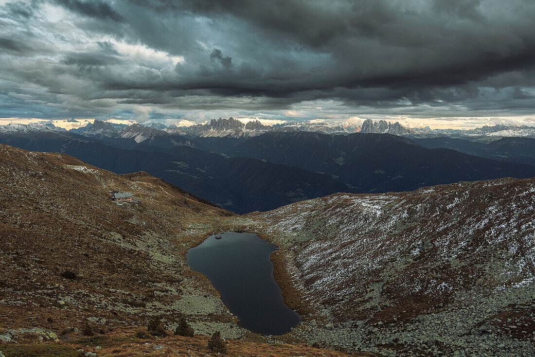 Lake Radlsee and Radlsee mountain hut, with the Dolomites, Unesco world heritage, in the background,  South Tyrol, Italy