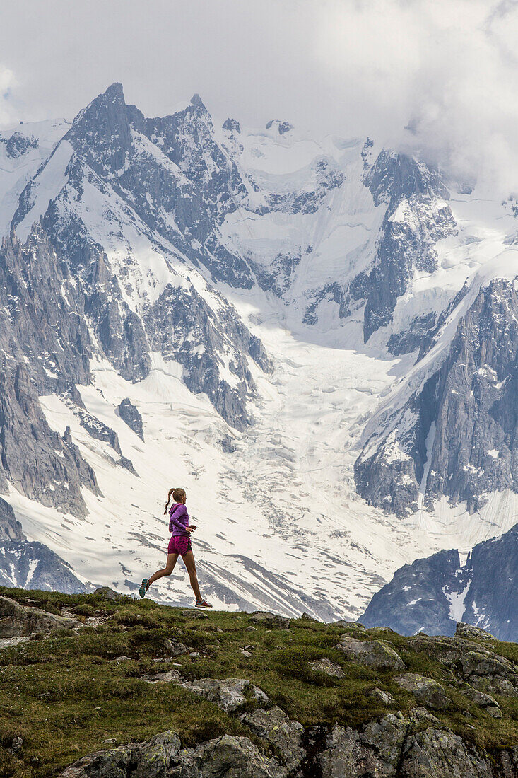 Girl trail running in Chamonix around the Chesery lake