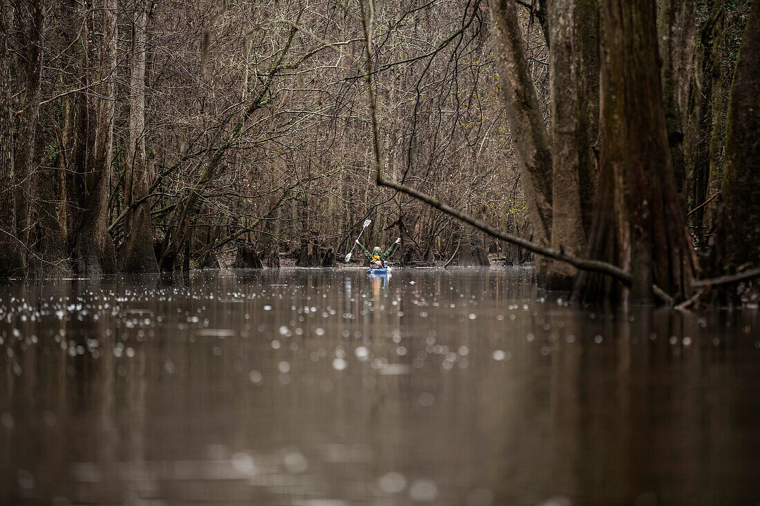 A kayaker celebrating on the water.