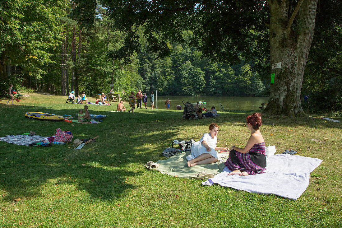 People enjoy sunny afternoon at Lake Schönsee and campground