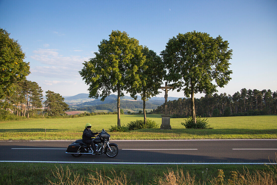 Man rides Harley-Davidson motorcycle on road near Point Alpha Memorial