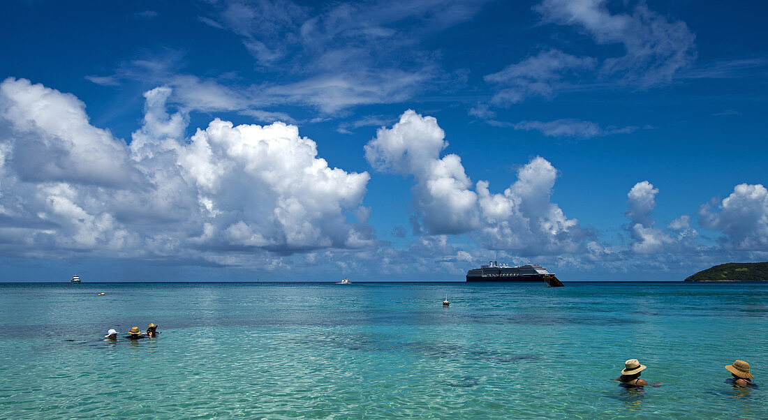 swimming on Dravuni Island, Fiji, with the MS Oosterdam in the background