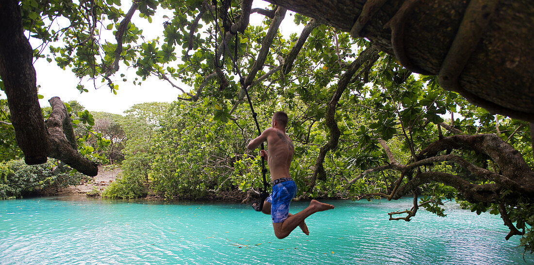 Visitor takes the plunge at the Blue Lagoon on the island of Efate