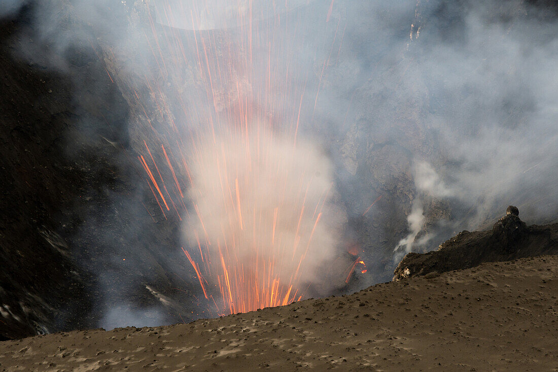 On the rim of the crater of the active volcano Yasur on the island of Tanna