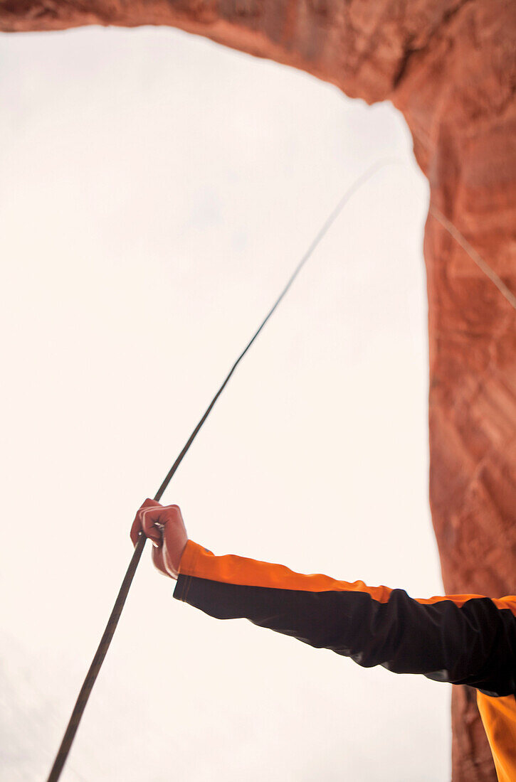 A woman holds her climbing rope.