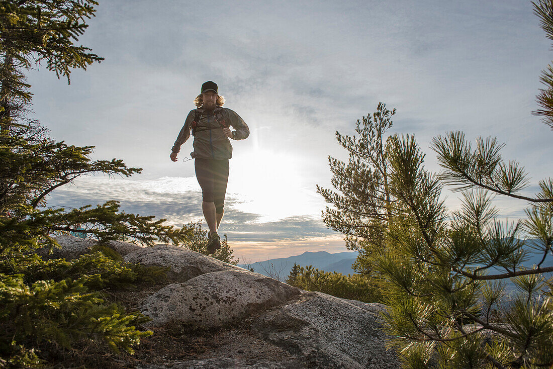 Trail runner on the granite rocks of the White Mountains of New Hampshire.