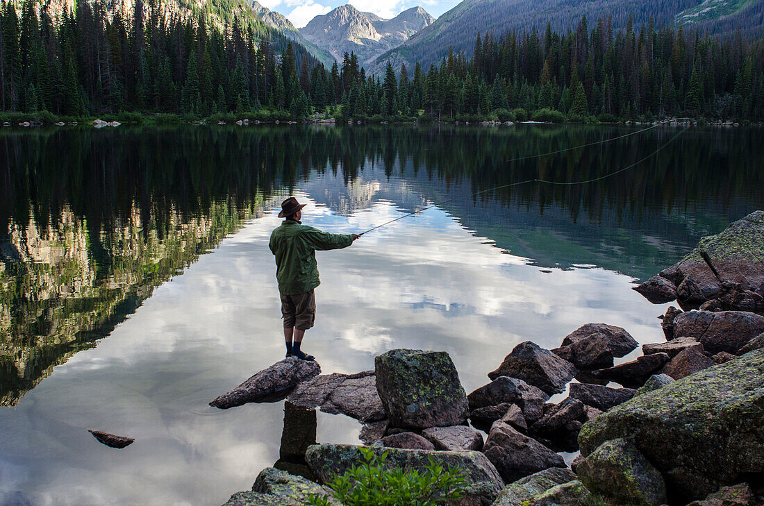 Photographer Jeremy Wade Shockley casts his fly line accross Emerald Lake, Weminuche Wilderness, Southwest Colorado.
