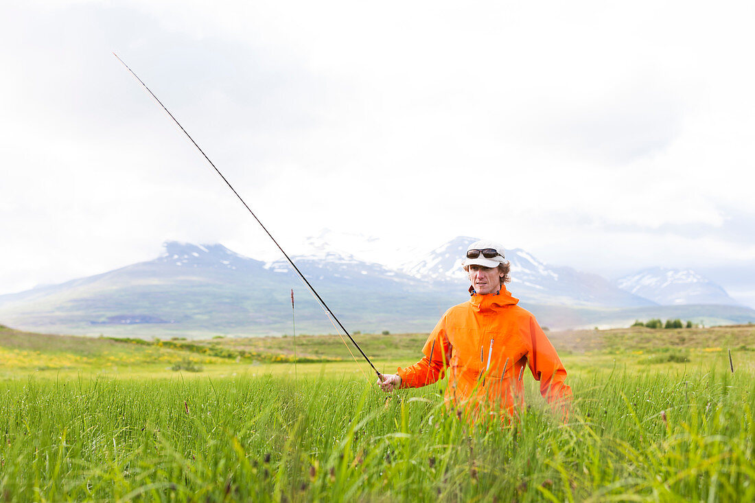 Man walking between pools while fly fishing on the river Hörgá, North Iceland.