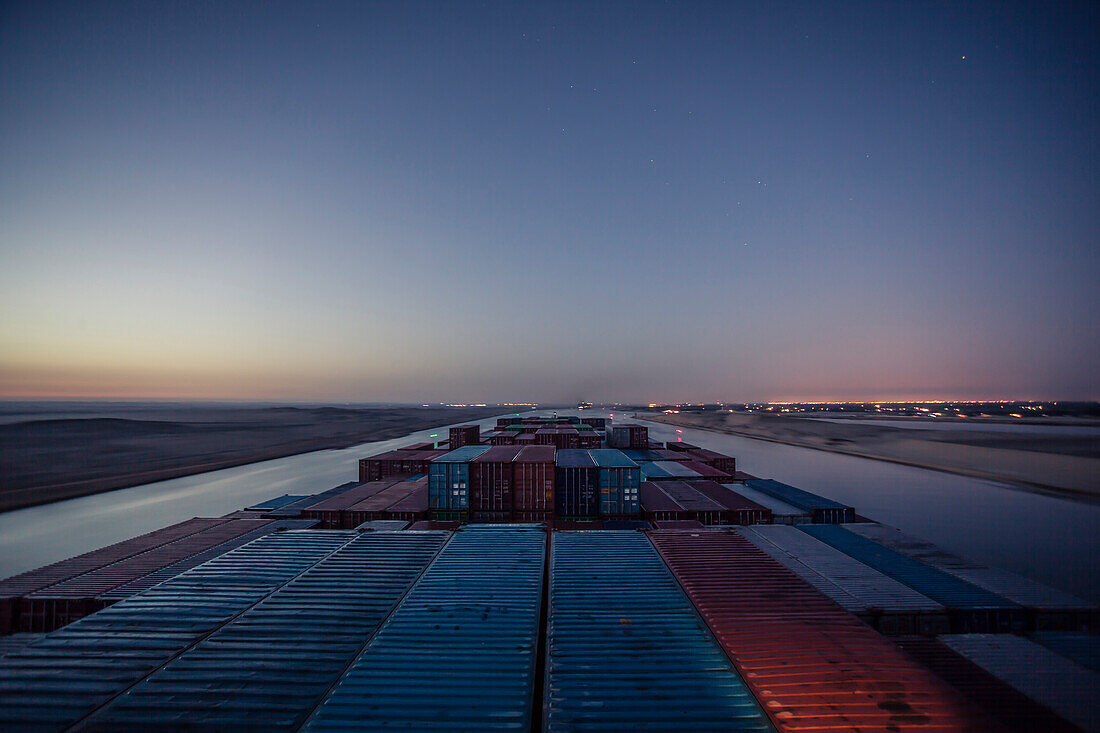 Container ship passing through the Suez Canal in the early hours of morning.