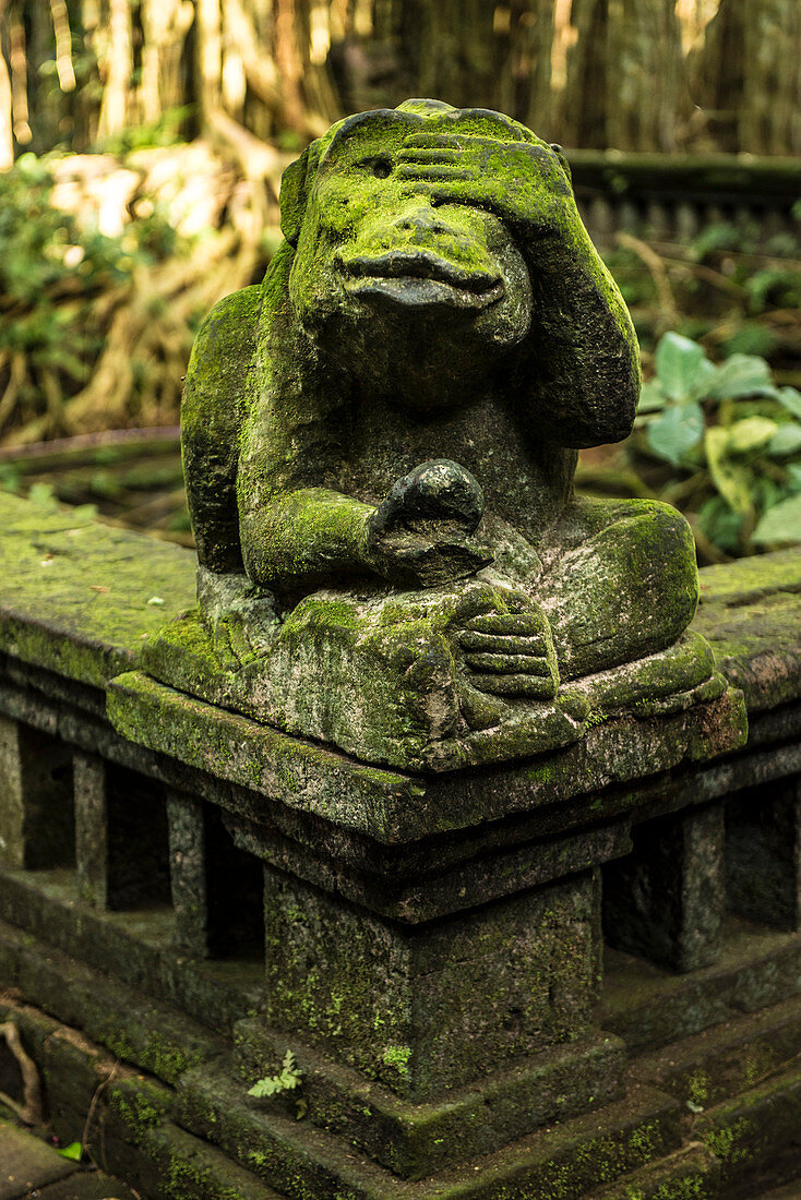 Balinese temple entrance with monkey statues in the temple town of Ubud, Bali, Indonesia