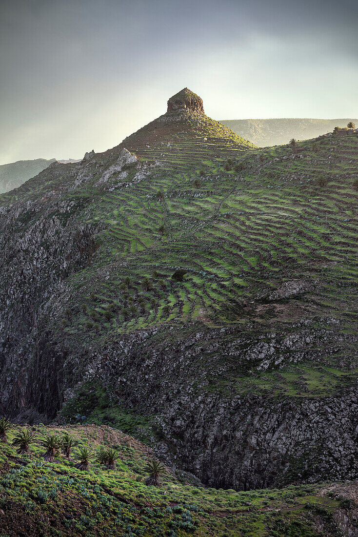 prominent rock formation and trails in the mountainous landscape around National Park Parque Nacional de Garajonay, La Gomera, Canary Islands, Spain