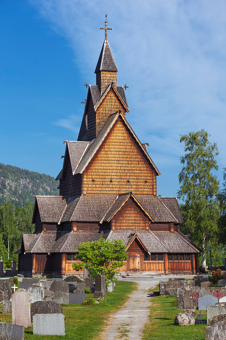 Heddal stave church with path and grave stones in summer, Notodden, Telemark, Norway, Scandinavia