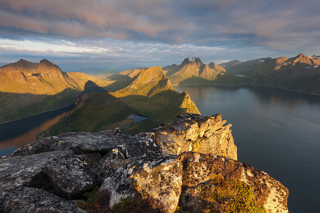 View from the top of Segla to the island of Senja with over 1000 m high mountains on the shores of Mefjorden in the last evening light, Fylke Troms, Norway, Scandinavia