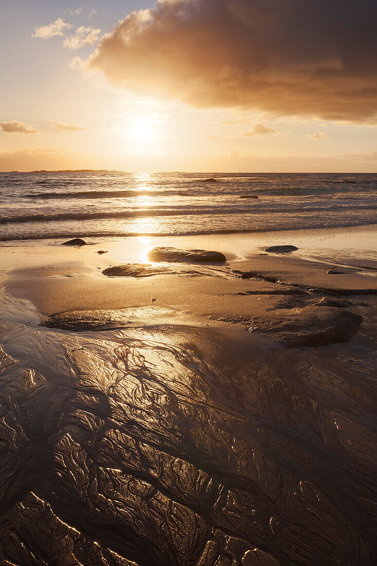 Intense sunset on the beach of Utakleiv with structures in the sand, Vestvågøy, Lofoten, Norway, Scandinavia