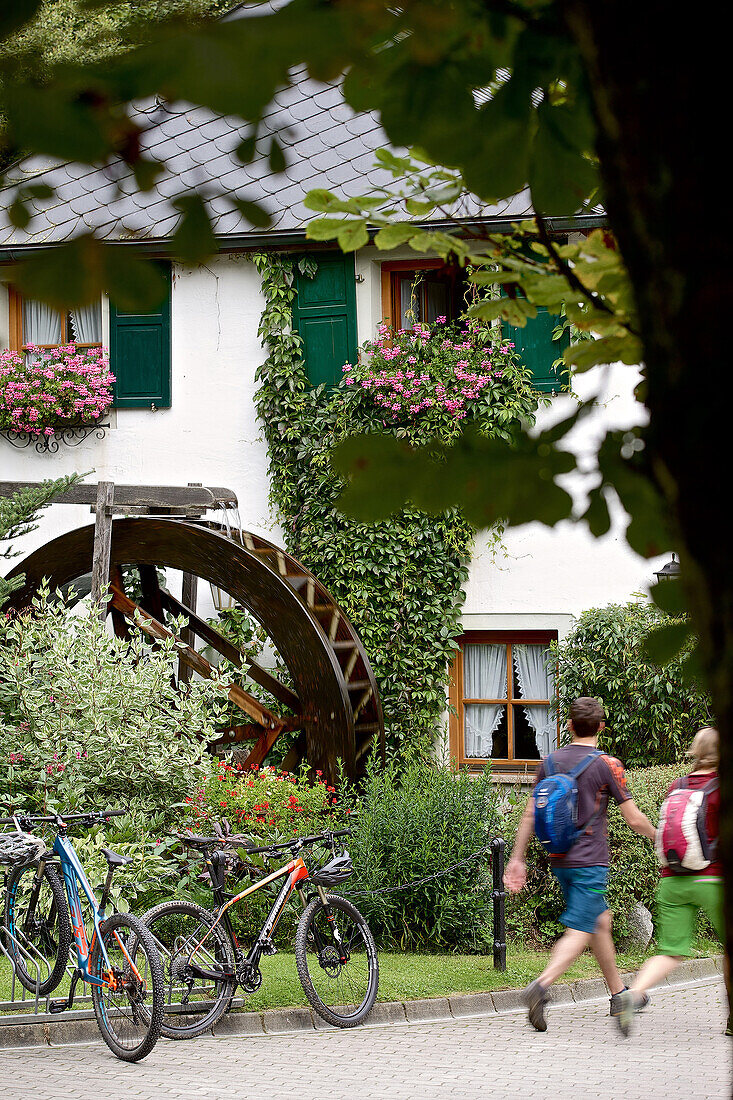 Two cyclist walking to a inn